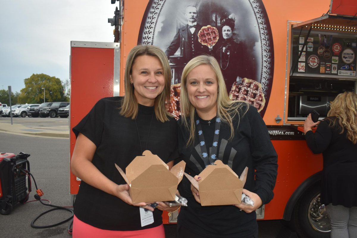 From left to right: Megan Drake and Tiffany Schadler with waffle in hand.